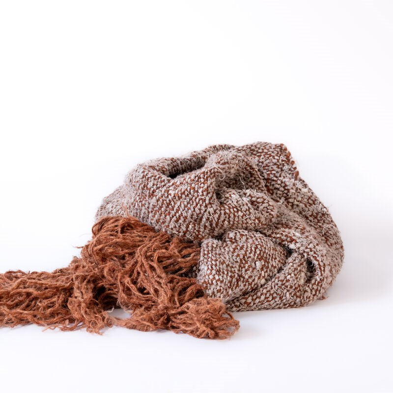 Knitted brown scarf on a white background