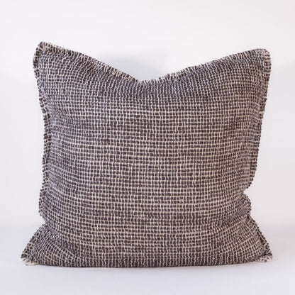 Textured dark pillow on a white background