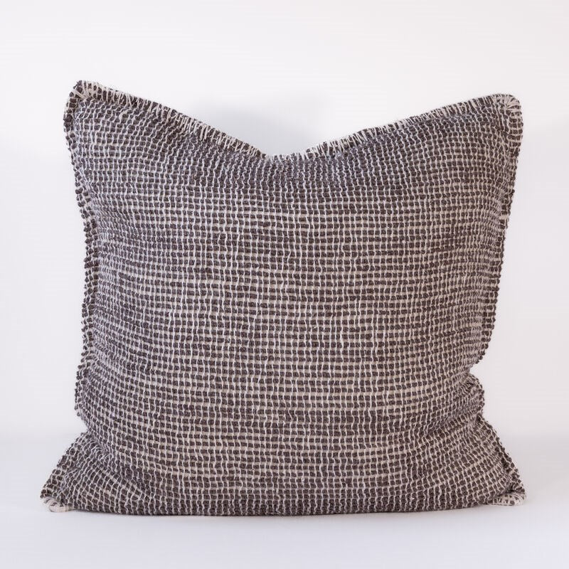 Textured dark pillow on a white background