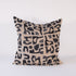 Decorative pillow with black abstract pattern on beige background
