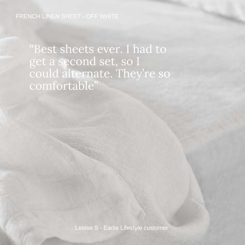 Close-up of white linen sheets with a quote from a customer praising them. &